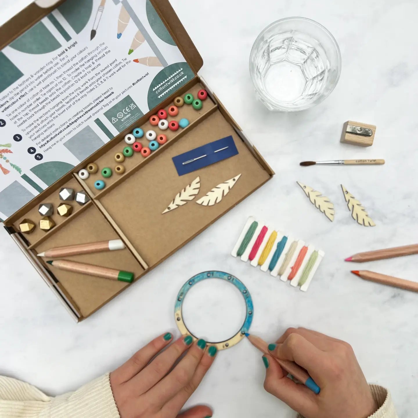 Crafting kit with tools and materials on a white surface