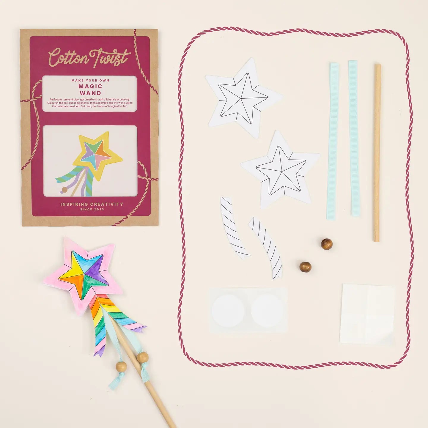Cotton Twist magic wand kit with colorful star wand, packaging, and materials on a beige background