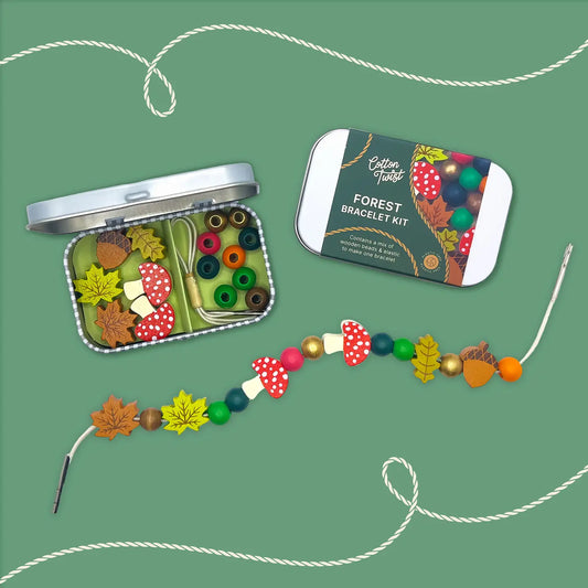 Forest bracelet kit with beads and tools in a tin on a white background