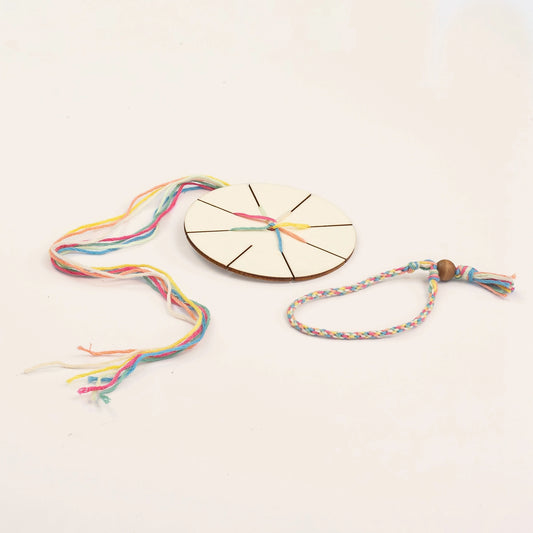 Colorful woven bracelet with a wooden disc and beads on a light background