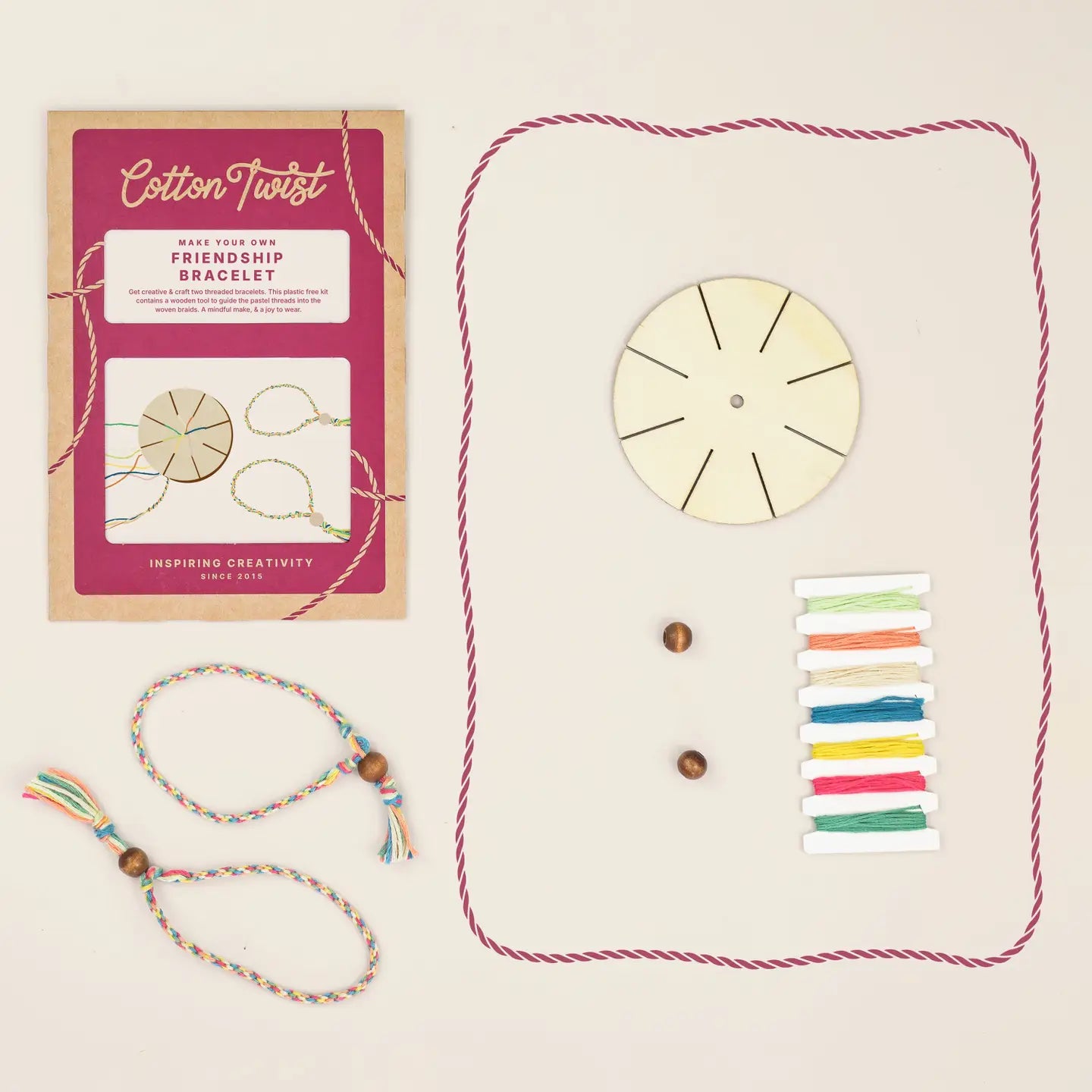 Cotton Twist friendship bracelet making kit with packaging, beads, and colorful strings on a beige background.