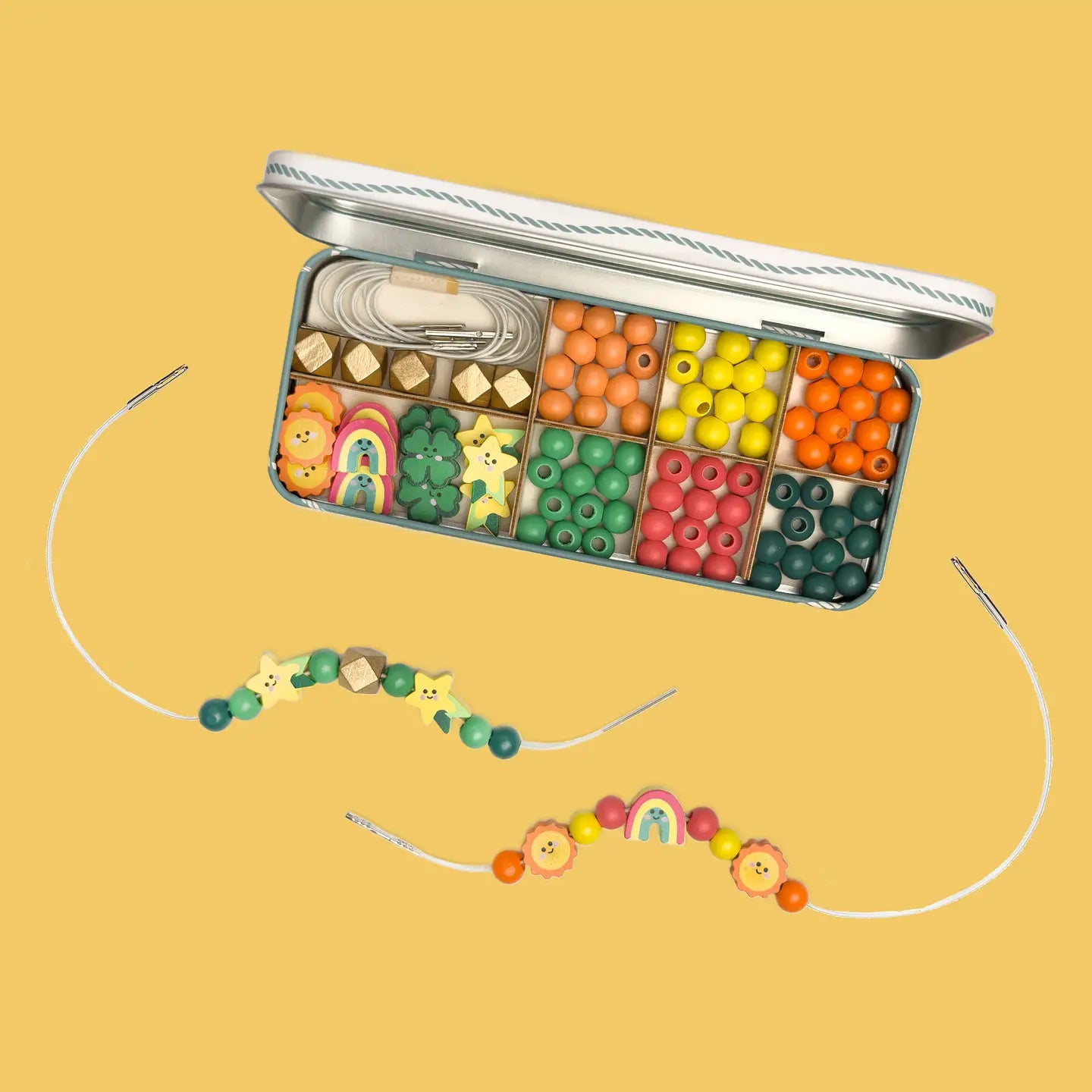Colorful bead set with jewelry-making tools on a yellow background